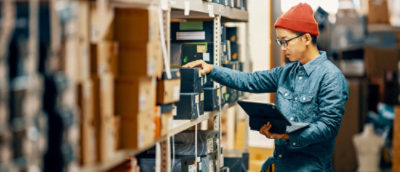A woman standing in a warehouse.