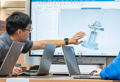 A man working on big computer screen.
