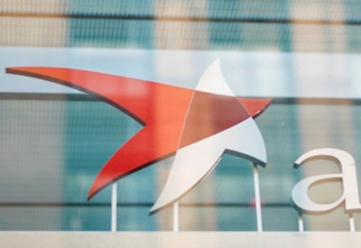 Orange and white color logo on building