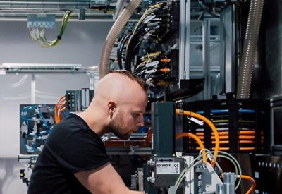 A man working on some electric wires.