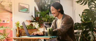A man sitting on the floor using a laptop.
