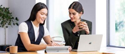 Two persons talking to each other at office desk