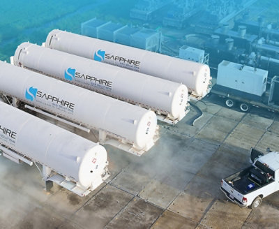 四個印有「SAPPHIRE」標誌的大型白色工業儲槽，置於戶外混凝土場地，旁邊停著一輛皮卡車。
