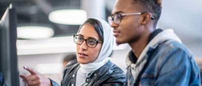 A man and woman looking at each other.