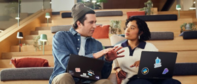 A man and woman sitting on a couch.