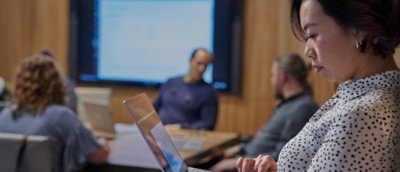 A group of people sitting in a meeting room.