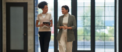 A group of women standing in front of a window.