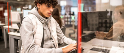 A blurry image of a person sitting in a chair.