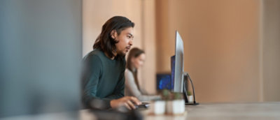 A person sitting at a desk using a computer.