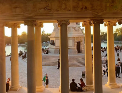 A group of people sitting on a stone walkway.