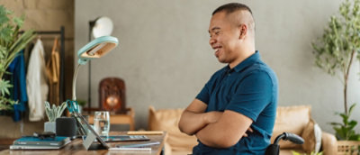 Ein Mann, der lächelt, während er auf den Bildschirm schaut