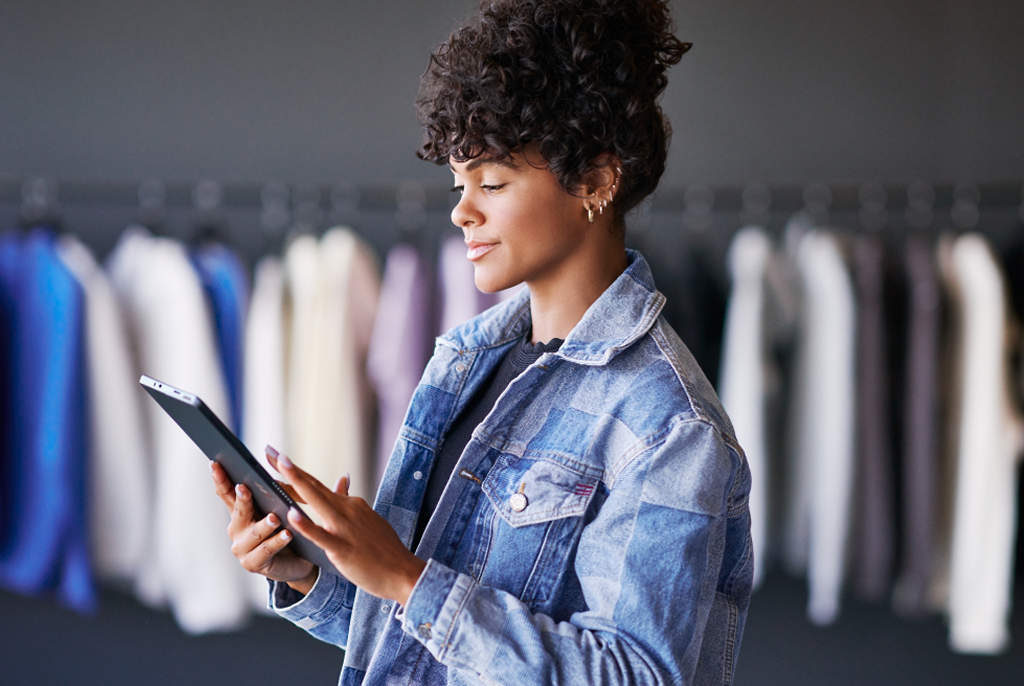 A woman in jackets checking tablet