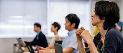 A group of people sitting in a meeting.