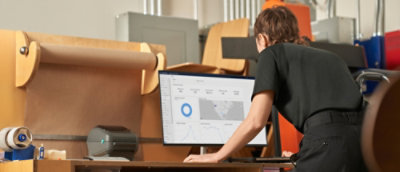 A person sitting at a desk with a computer.