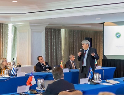 A man in a suit speaking into a microphone.