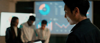 A blurry image of a person looking at a screen.