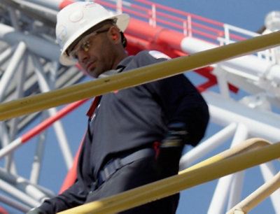 A man wearing a hard hat and glasses.