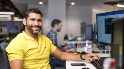 A person sitting at a desk with a computer screen.