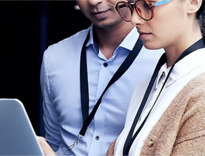 A man and woman looking at a tablet.