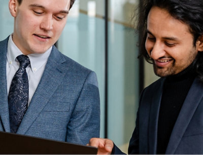 Two men looking at a computer screen.