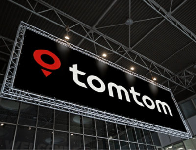 A sign with a red circle and white text spelling tomtom.