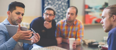 A group of men sitting at a table.