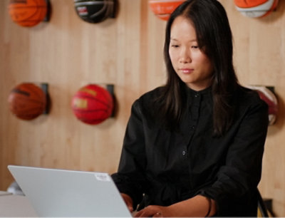A woman looking at her laptop.