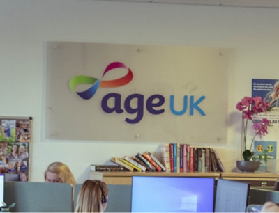 A colorful logo with the text Age UK on a wall.