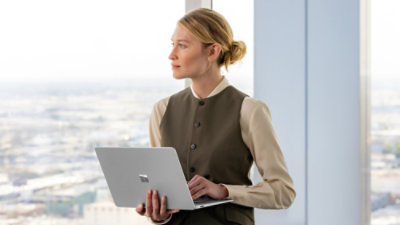 A person holding a laptop.