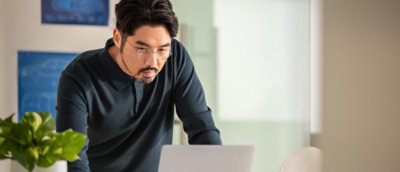 A man looking at a laptop screen.