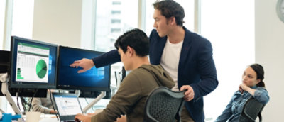 A man pointing at a computer screen.