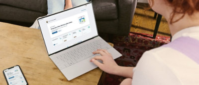 A person typing on a laptop at a table.
