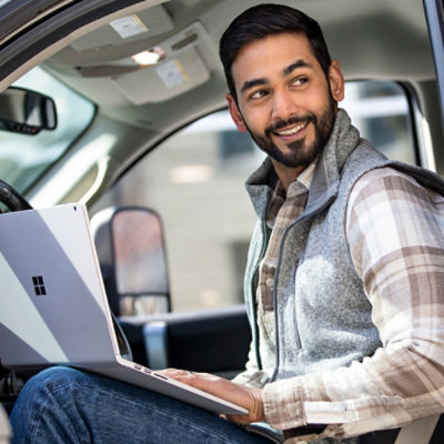 Person in vehicle using a laptop.
