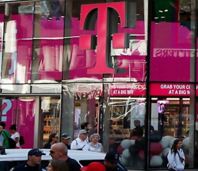 T-Mobile storefront with pink logo and promotional sign.
