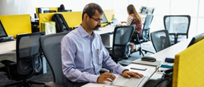 Person working on laptop in office.