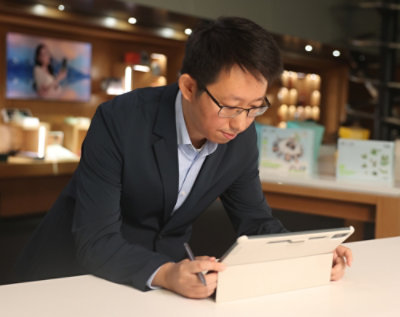 A man and a googles wearing women discussing something with a laptop