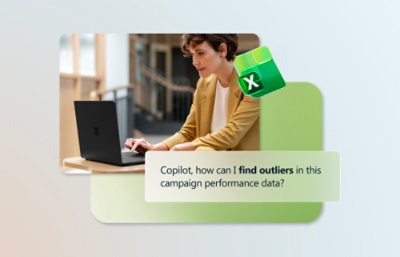 A laptop screen showing text and a green and white X sign, with a woman sitting at a desk in the background.