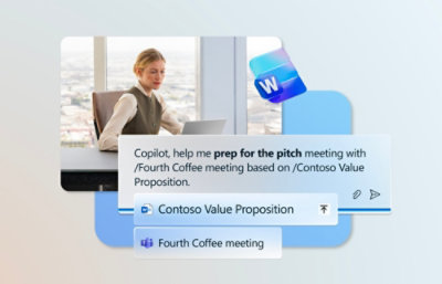 A woman sitting at a table using a laptop.