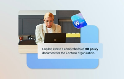 A person in a white suit sitting at a desk using a laptop with partially visible text on the screen.