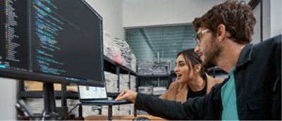 Two people discussing while looking at the laptop
