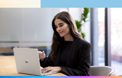 A person sitting at a desk using a laptop.
