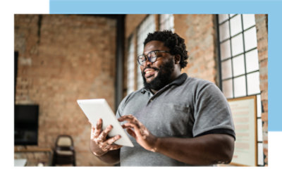 A person with glasses using a tablet