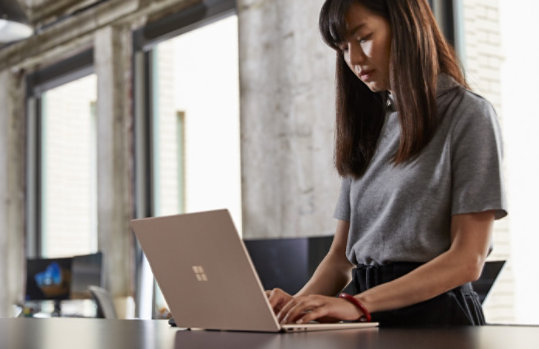 A person works on a Surface device.