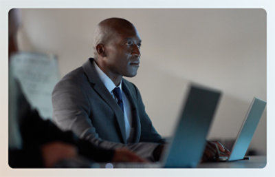 A man in a coat sitting looking away