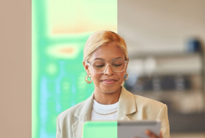 A women holding a tab and looking into screen.