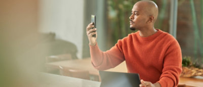 A man taking selfi with his phone.