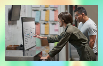 A women showing something on screen to a man