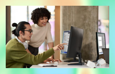 A man and a women looking into laptop screen.