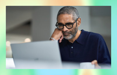 A man looking into laptop screen.