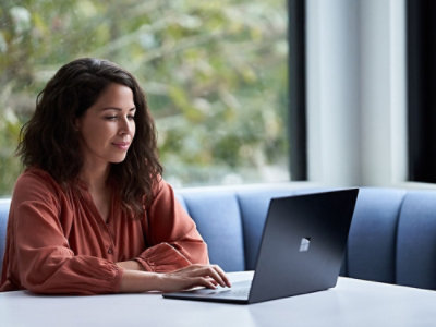 A person sitting at a table using a computer